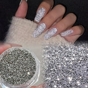 A Box of Tiny Silvery Triangular 3D Glittering Rhinestones, Perfect for Parties, Nightclubs, Music Festivals, And Vacation Nail Art Accessories.