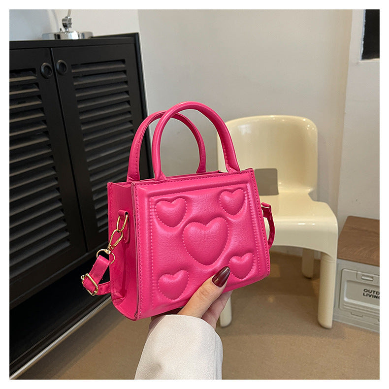 1pc Women’s Stylish Solid Color Handbag with Detachable Strap – Heart Pattern Design, Perfect for Valentine’s Day Gift, Available in Magenta, White, Black, Green, Yellow
