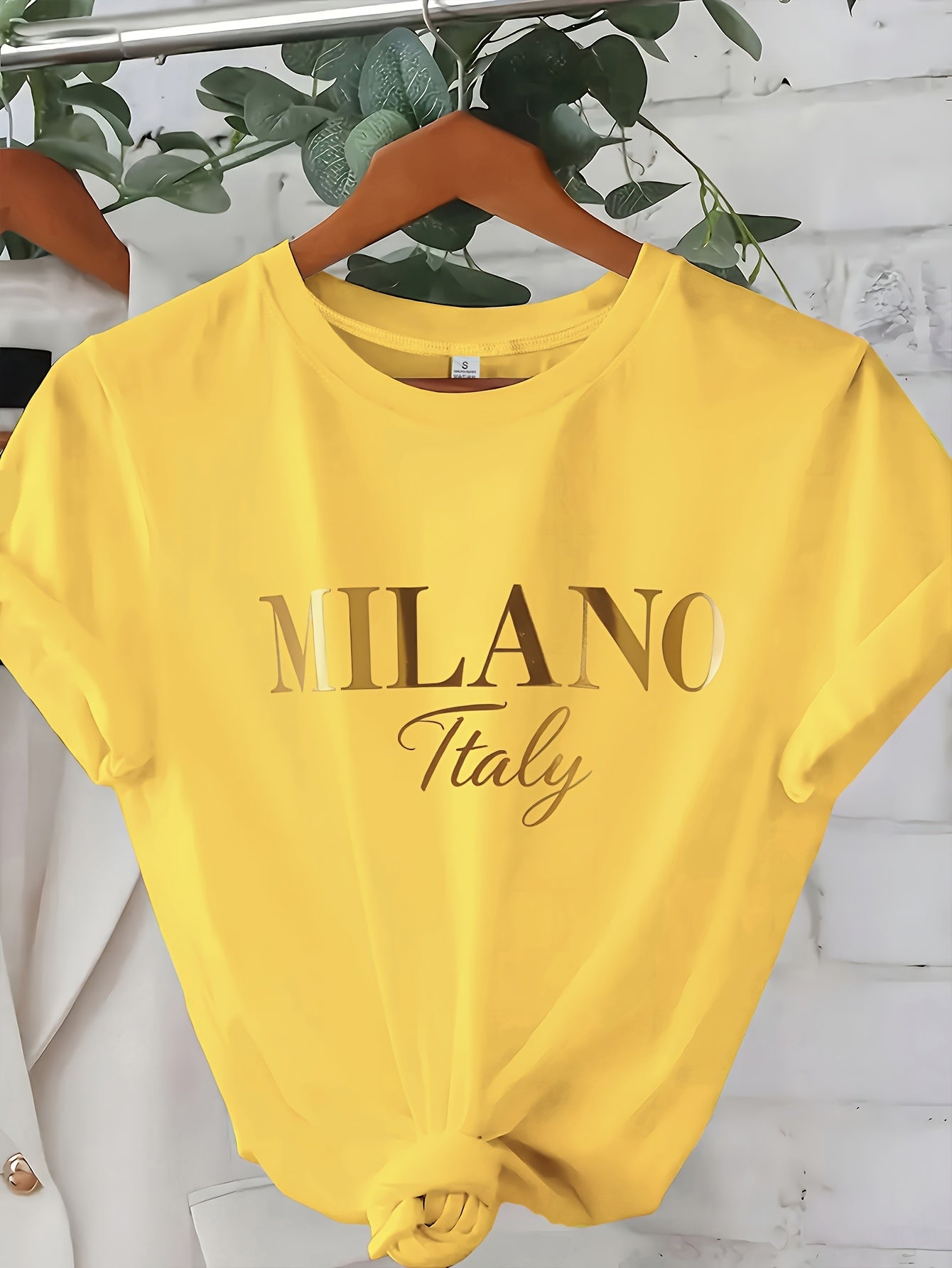 C571 Exuding elegance and modern luxury the design features MILANO in bold shimmering Golden uppercase letters with ITALY elegantly scripted in a smaller lighter font directly beneath all set against a deep black background T