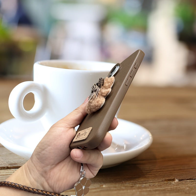 A Single-Pack Plush Teddy Bear Phone Case with a Bow, Available in White And Brown. It Comes with a Wrist Strap And Features a Simple And Elegant Faux Leather Texture That Is Anti-Slip And Fingerprint-Resistant. Made with TPU