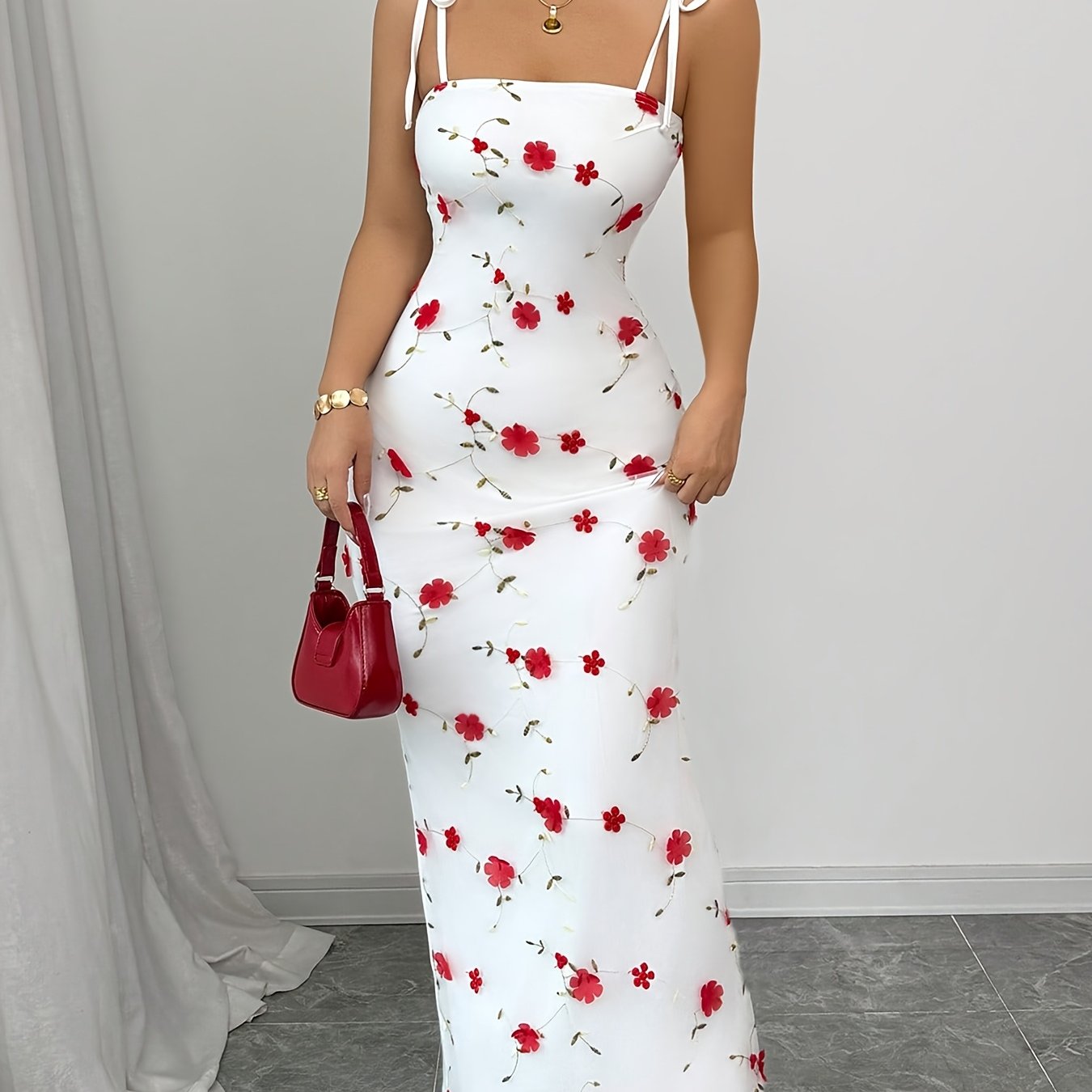 A Simple, Fitted Long Dress with Thin Shoulder Straps And a Waist Belt.