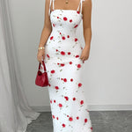 A Simple, Fitted Long Dress with Thin Shoulder Straps And a Waist Belt.