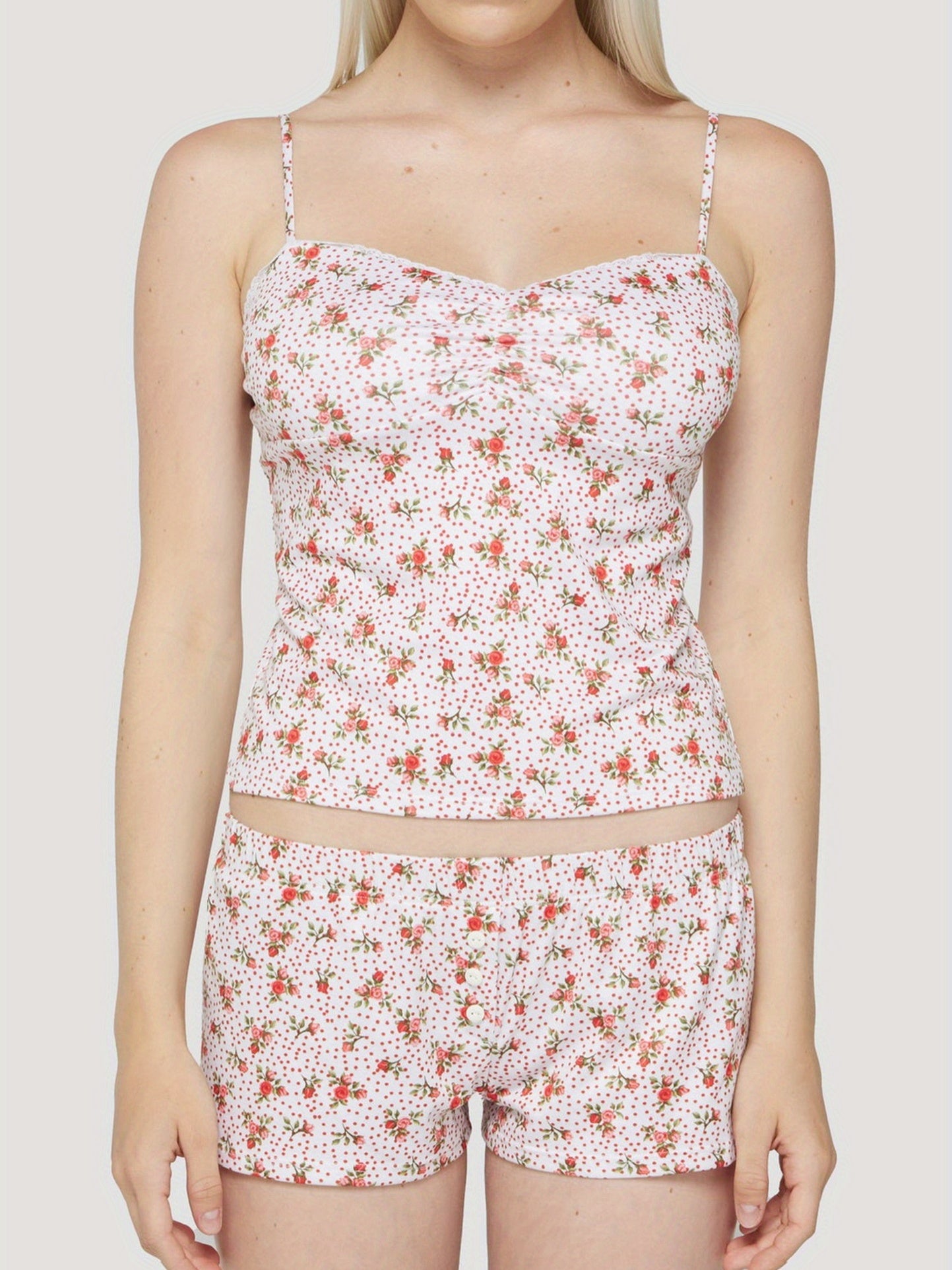 Women's pyjama set with halter neck, backless and matching shorts; floral and polka dot print. 95% polyester, 5% elastane, smooth to the touch, very soft, perfect for days spent at home, nights spent sleeping.
