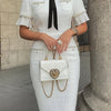 Mid-Length Dress with Elegant Pleats, Pearl Trim, And Velvet Bow Design.