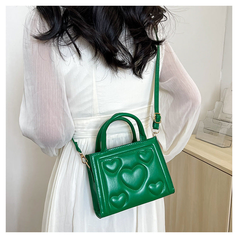 1pc Women’s Stylish Solid Color Handbag with Detachable Strap – Heart Pattern Design, Perfect for Valentine’s Day Gift, Available in Magenta, White, Black, Green, Yellow