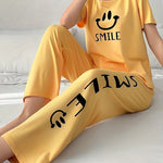 Women's Smiling Face & Letter Print Casual Pajama Set, Short Sleeve Round Neck Top & Pants, Comfortable Relaxed Fit