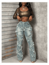 Vintage-style women's water-washed distressed pants with slit at the hem, made of denim fabric.