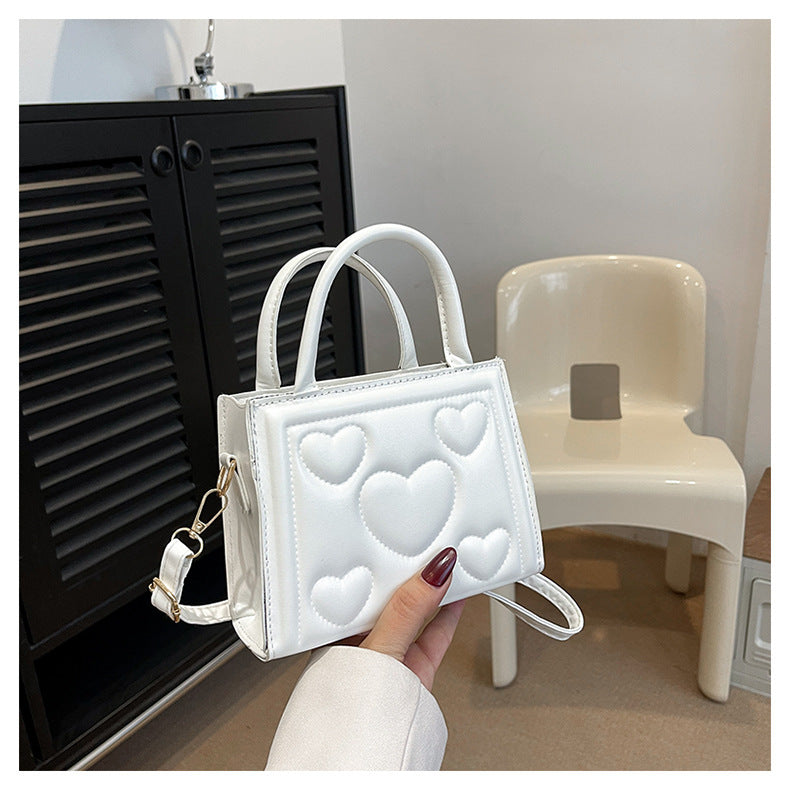 1pc Women’s Stylish Solid Color Handbag with Detachable Strap – Heart Pattern Design, Perfect for Valentine’s Day Gift, Available in Magenta, White, Black, Green, Yellow