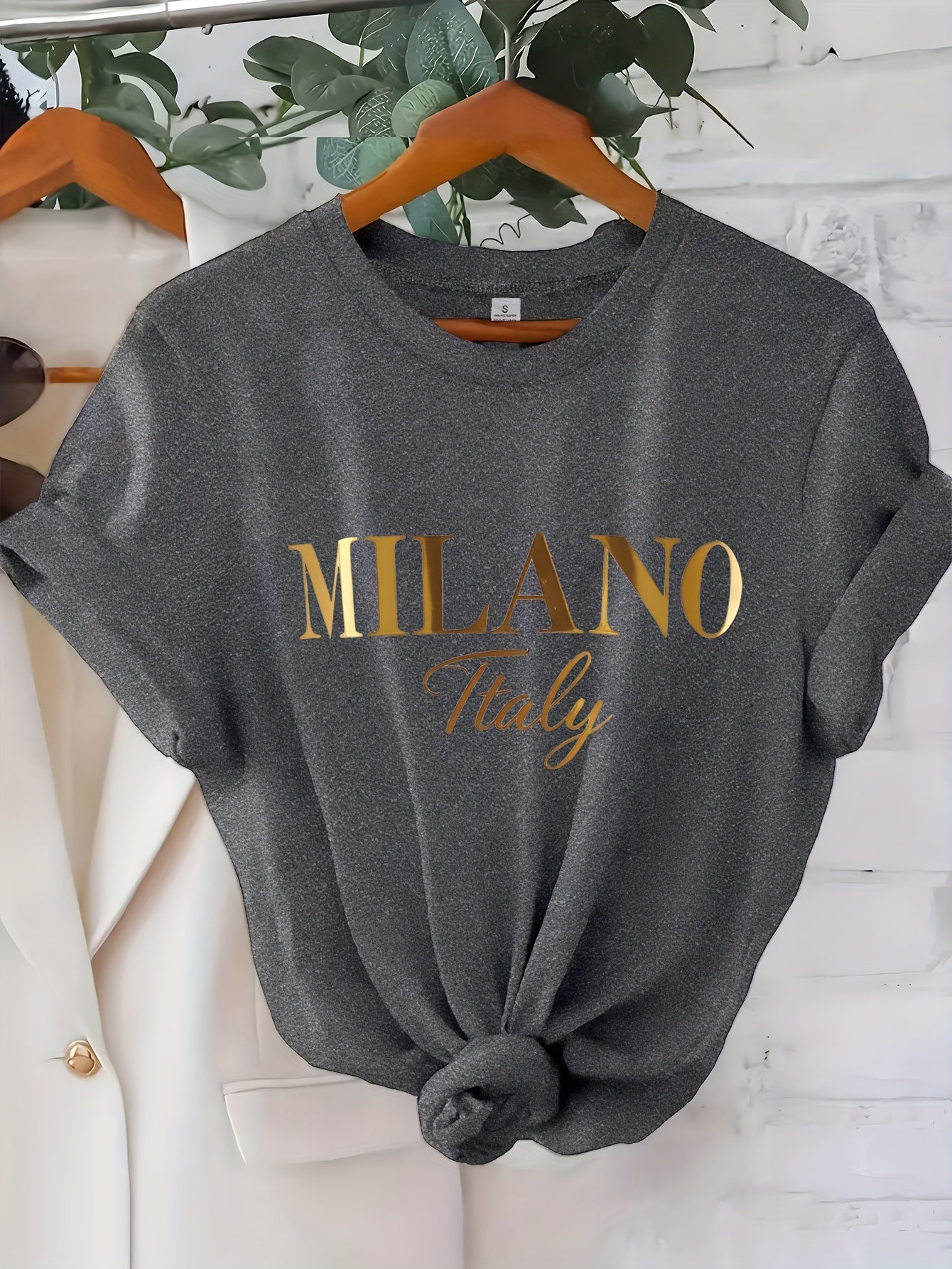C571 Exuding elegance and modern luxury the design features MILANO in bold shimmering Golden uppercase letters with ITALY elegantly scripted in a smaller lighter font directly beneath all set against a deep black background T