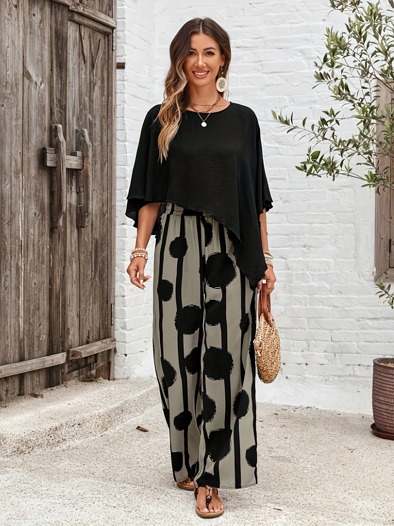 A Two-Piece Women'S Solid Color Round Neck Asymmetrical Hem Shirt And All-Over Printed Pants Set.