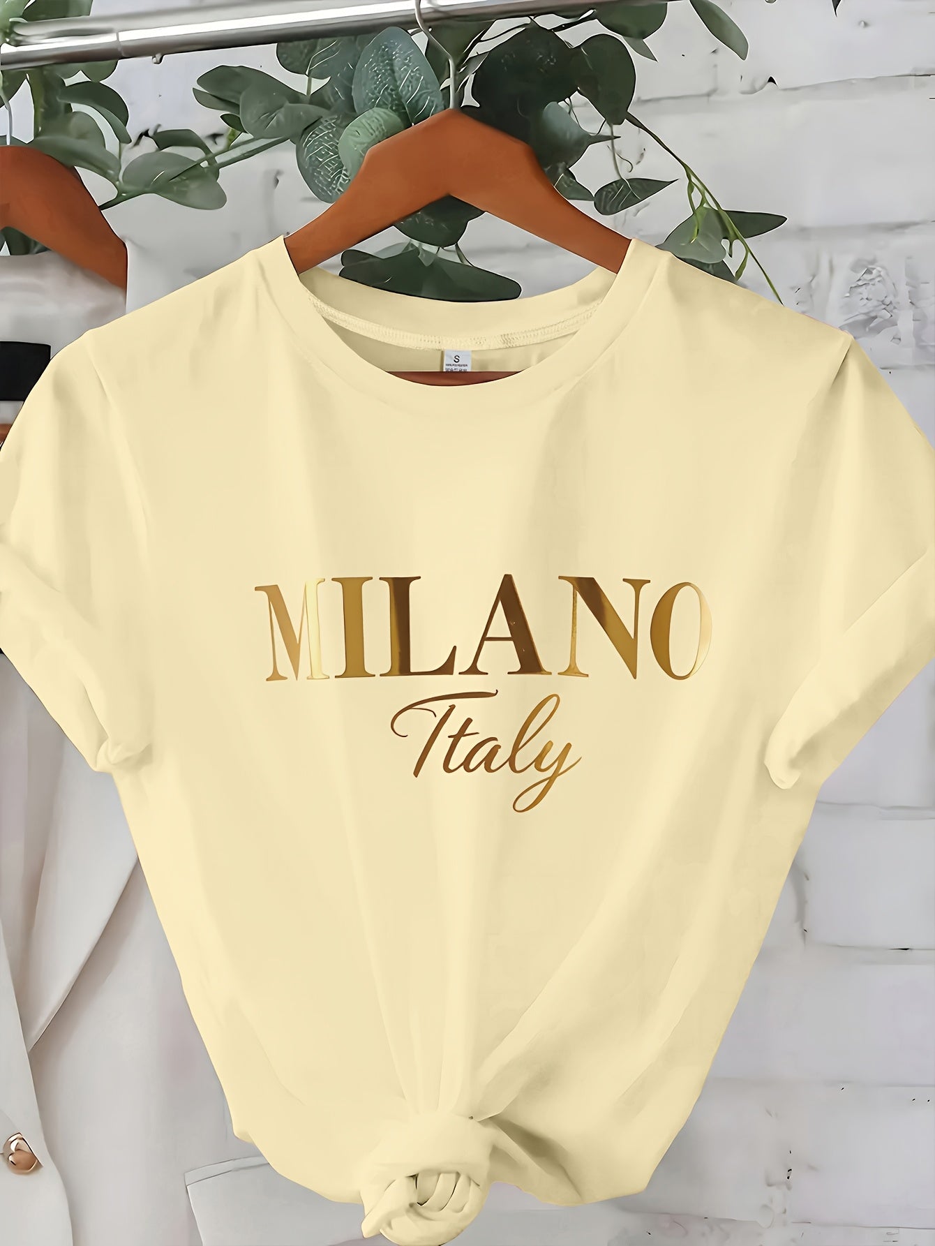C571 Exuding elegance and modern luxury the design features MILANO in bold shimmering Golden uppercase letters with ITALY elegantly scripted in a smaller lighter font directly beneath all set against a deep black background T