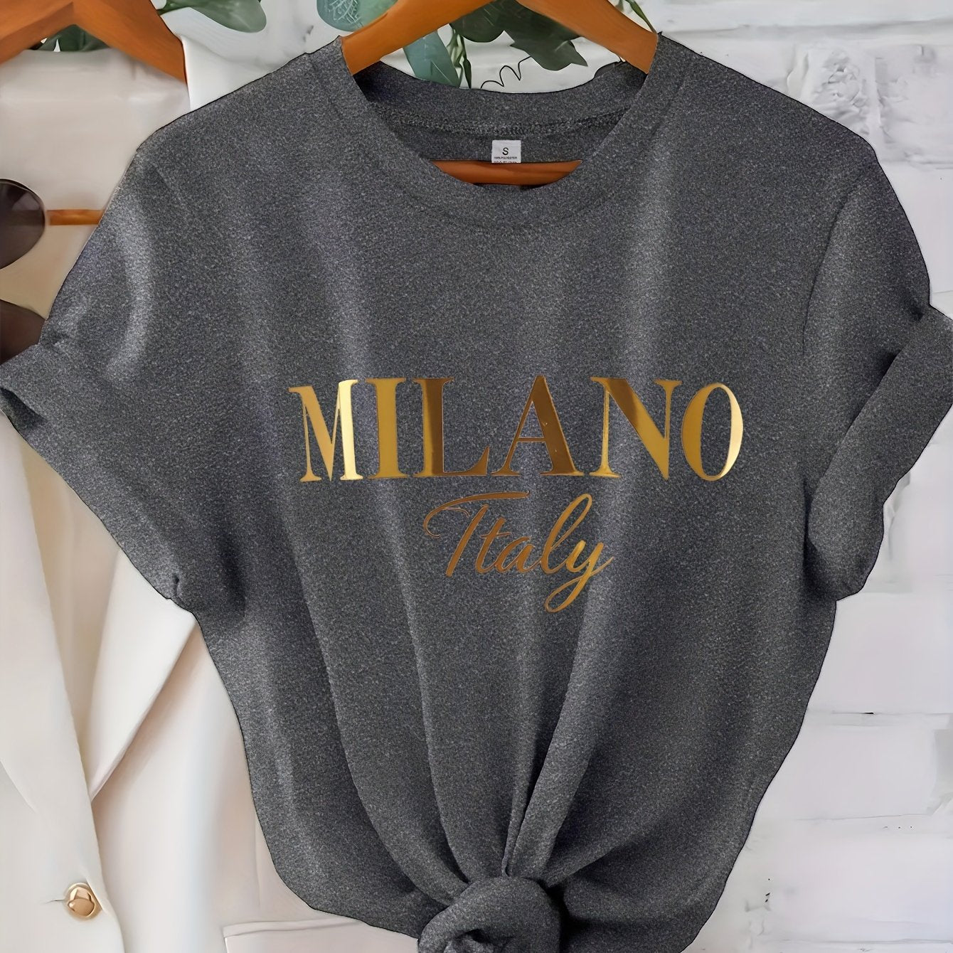 C571 Exuding elegance and modern luxury the design features MILANO in bold shimmering Golden uppercase letters with ITALY elegantly scripted in a smaller lighter font directly beneath all set against a deep black background T