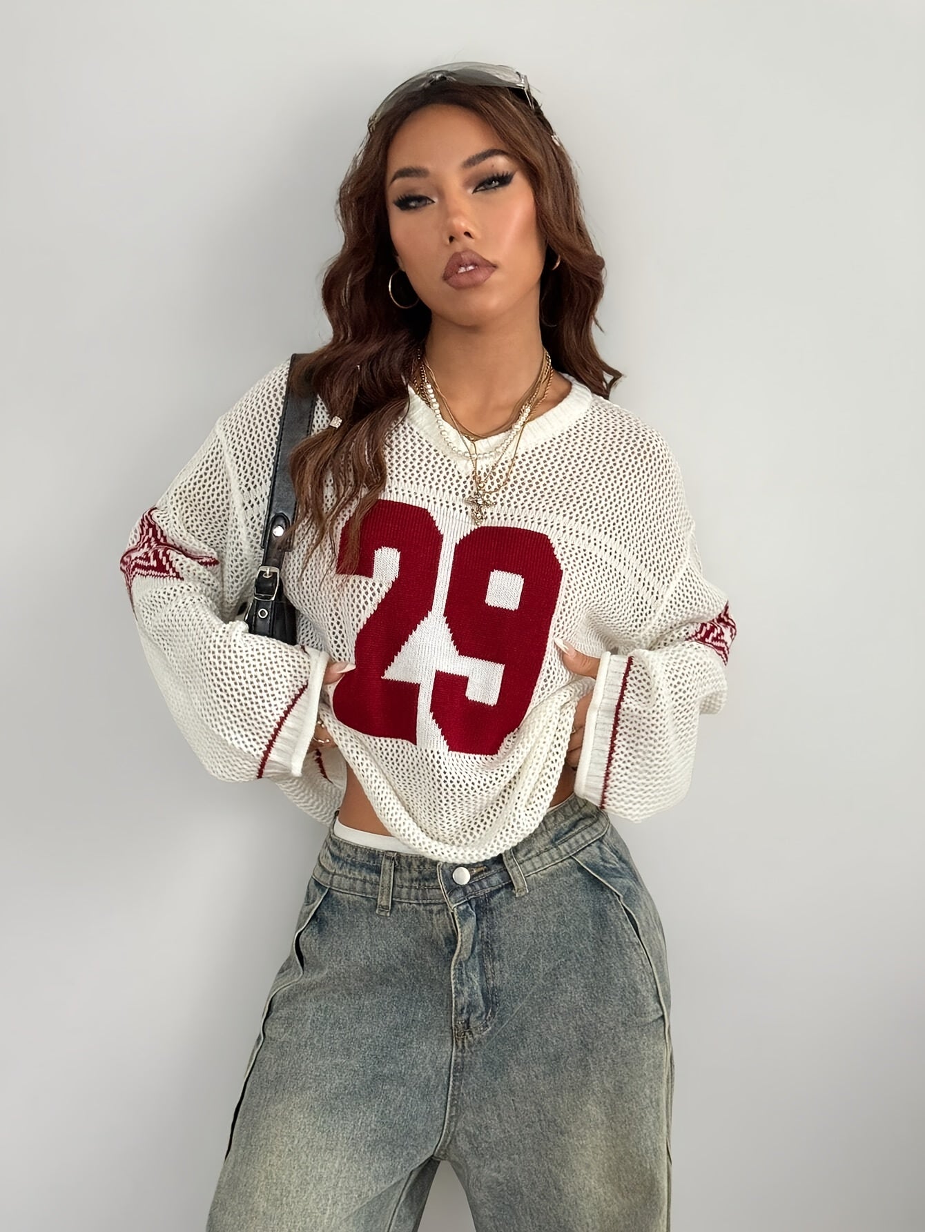 A Oversized Knitted Sweater with Striped And Number Prints, Featuring Long Sleeves.
