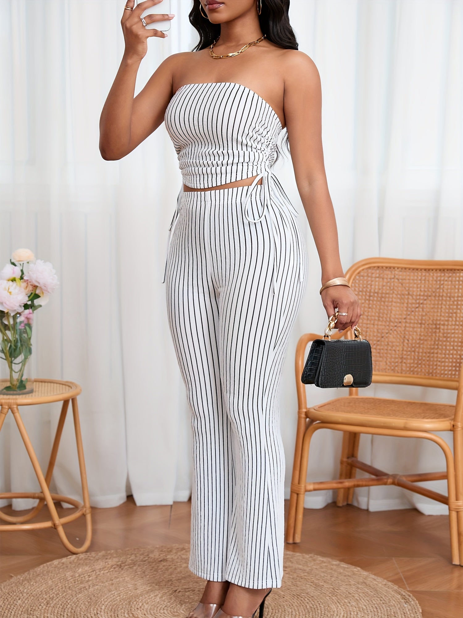 A Two-Piece Set Featuring a Textured Wrinkled Fabric Strapless Top with Drawstring And Fitted Flared Long Pants.