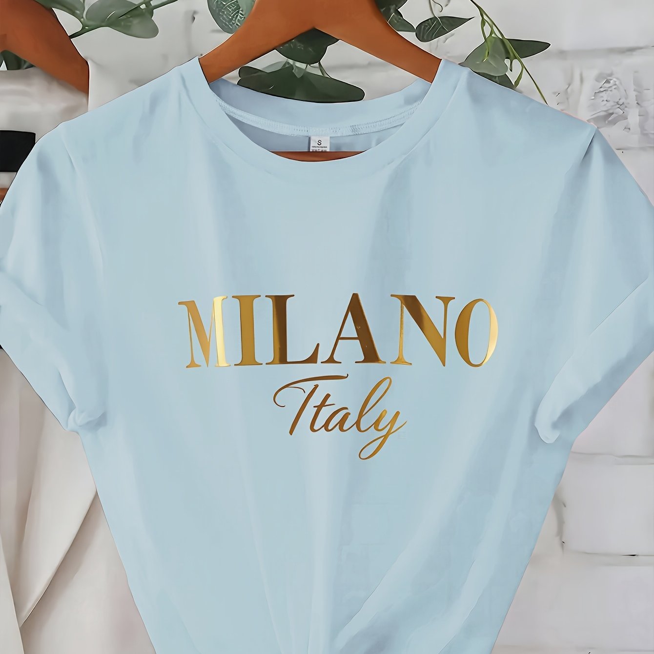 C571 Exuding elegance and modern luxury the design features MILANO in bold shimmering Golden uppercase letters with ITALY elegantly scripted in a smaller lighter font directly beneath all set against a deep black background T
