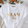 C571 Exuding elegance and modern luxury the design features MILANO in bold shimmering Golden uppercase letters with ITALY elegantly scripted in a smaller lighter font directly beneath all set against a deep black background T