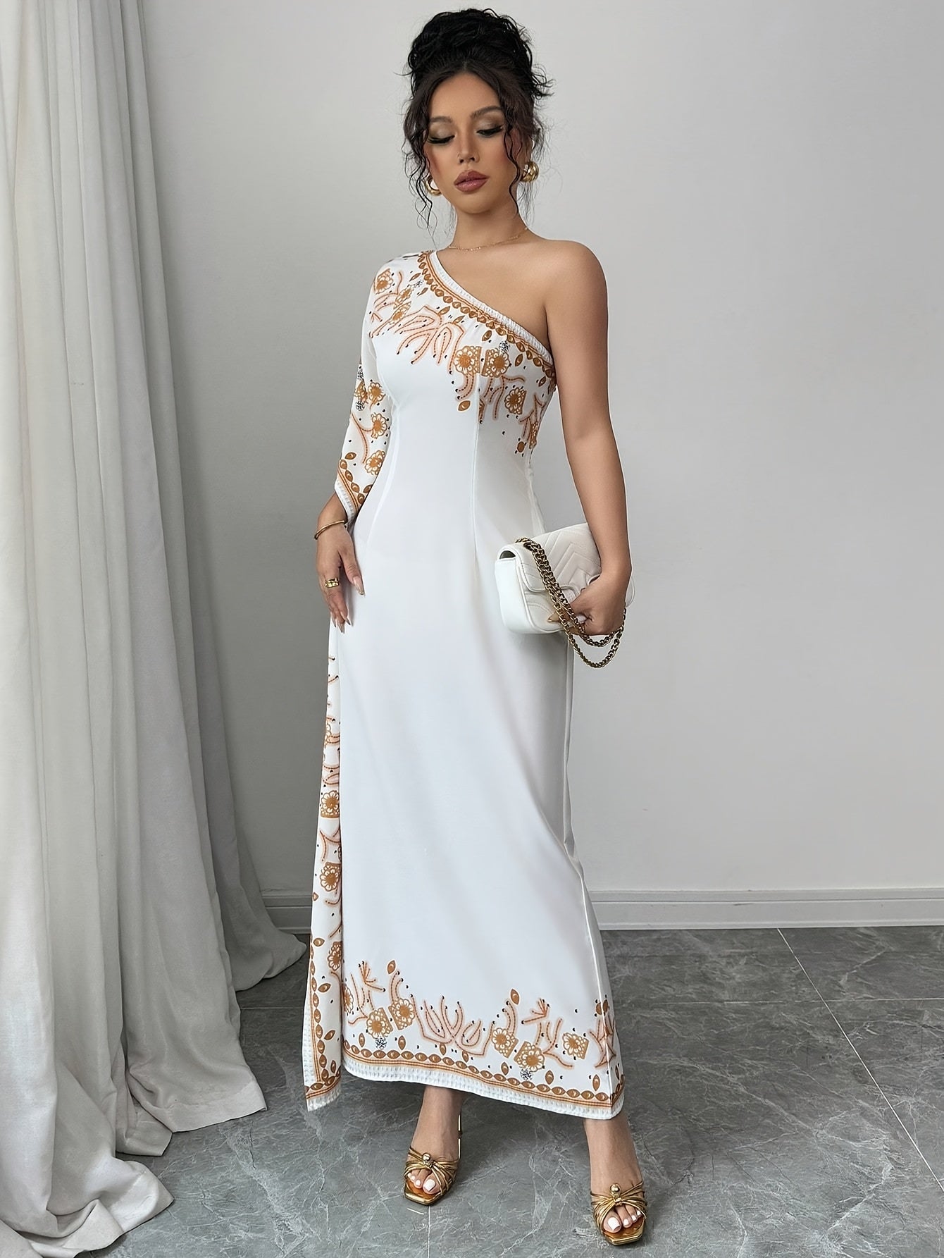 An Elegant Long Dress with an Asymmetrical Floral Print on The Shoulder, Suitable for Formal Occasions.