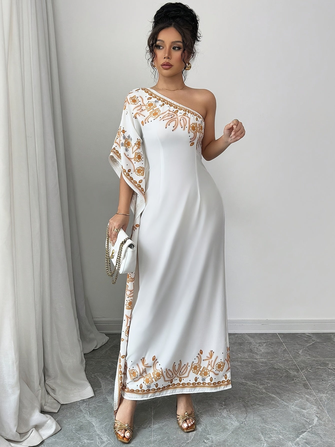 An Elegant Long Dress with an Asymmetrical Floral Print on The Shoulder, Suitable for Formal Occasions.