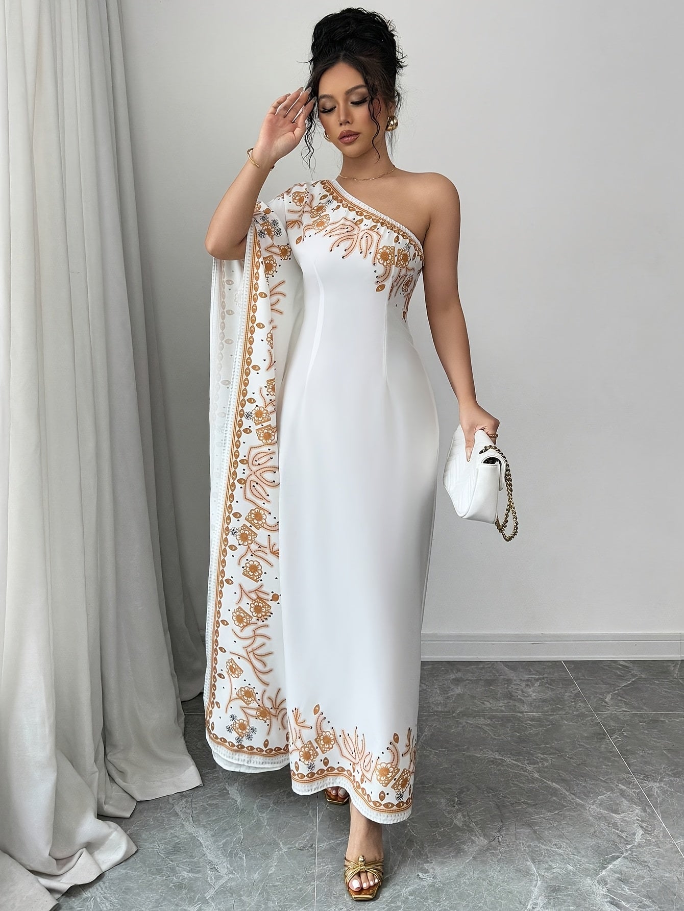 An Elegant Long Dress with an Asymmetrical Floral Print on The Shoulder, Suitable for Formal Occasions.