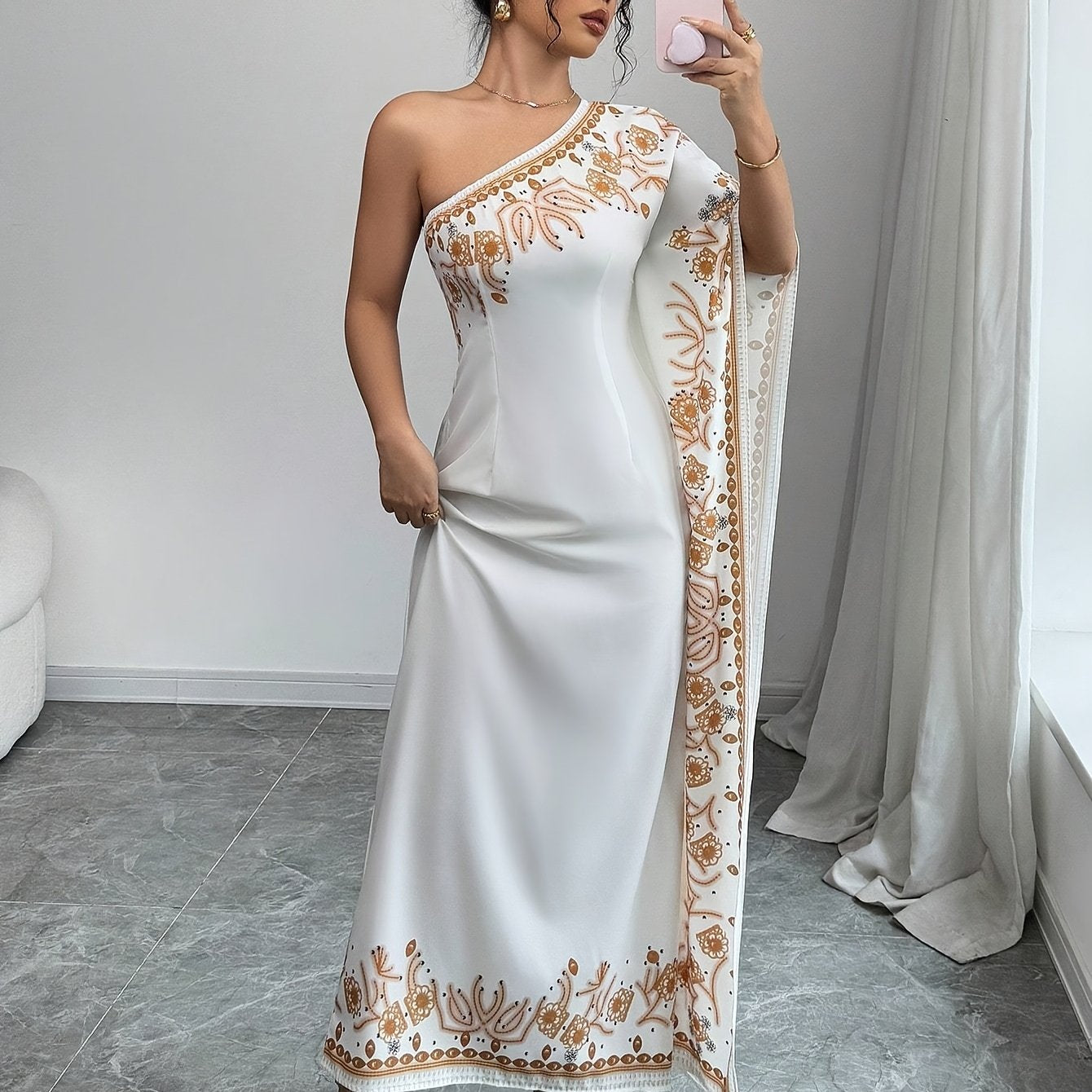An Elegant Long Dress with an Asymmetrical Floral Print on The Shoulder, Suitable for Formal Occasions.