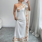 An Elegant Long Dress with an Asymmetrical Floral Print on The Shoulder, Suitable for Formal Occasions.