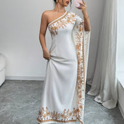 An Elegant Long Dress with an Asymmetrical Floral Print on The Shoulder, Suitable for Formal Occasions.