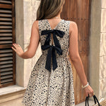 Elegant Floral Midi Dress for Women - Sleeveless Crew Neck with Black Bow Detail, Spring/Summer/Fall Fashion, Floral Print Peplum Dress