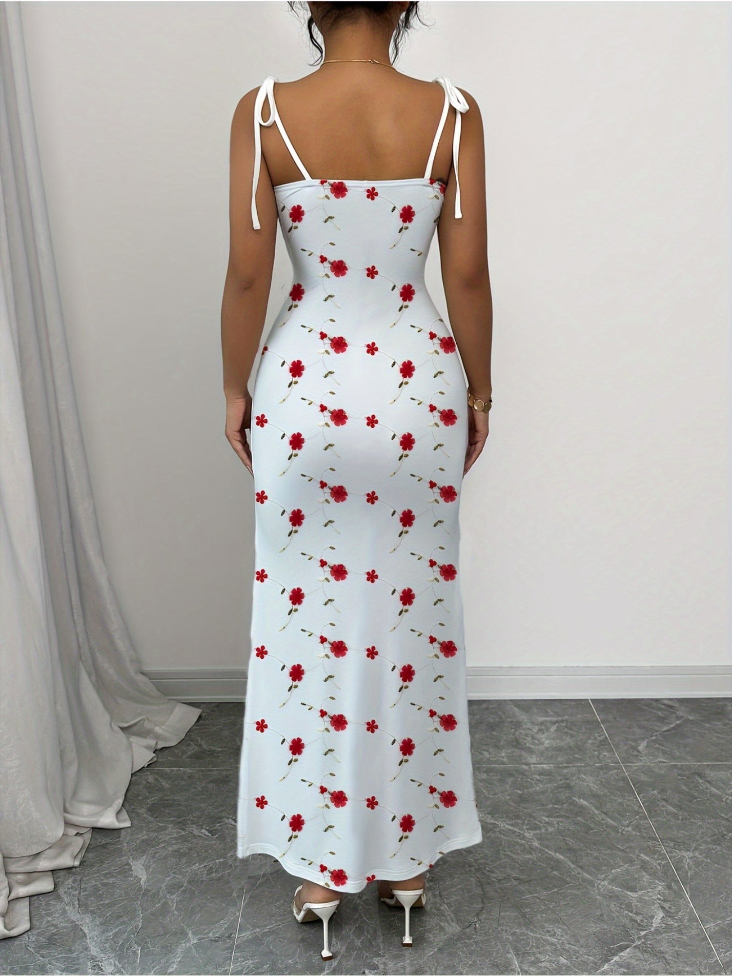 A Simple, Fitted Long Dress with Thin Shoulder Straps And a Waist Belt.