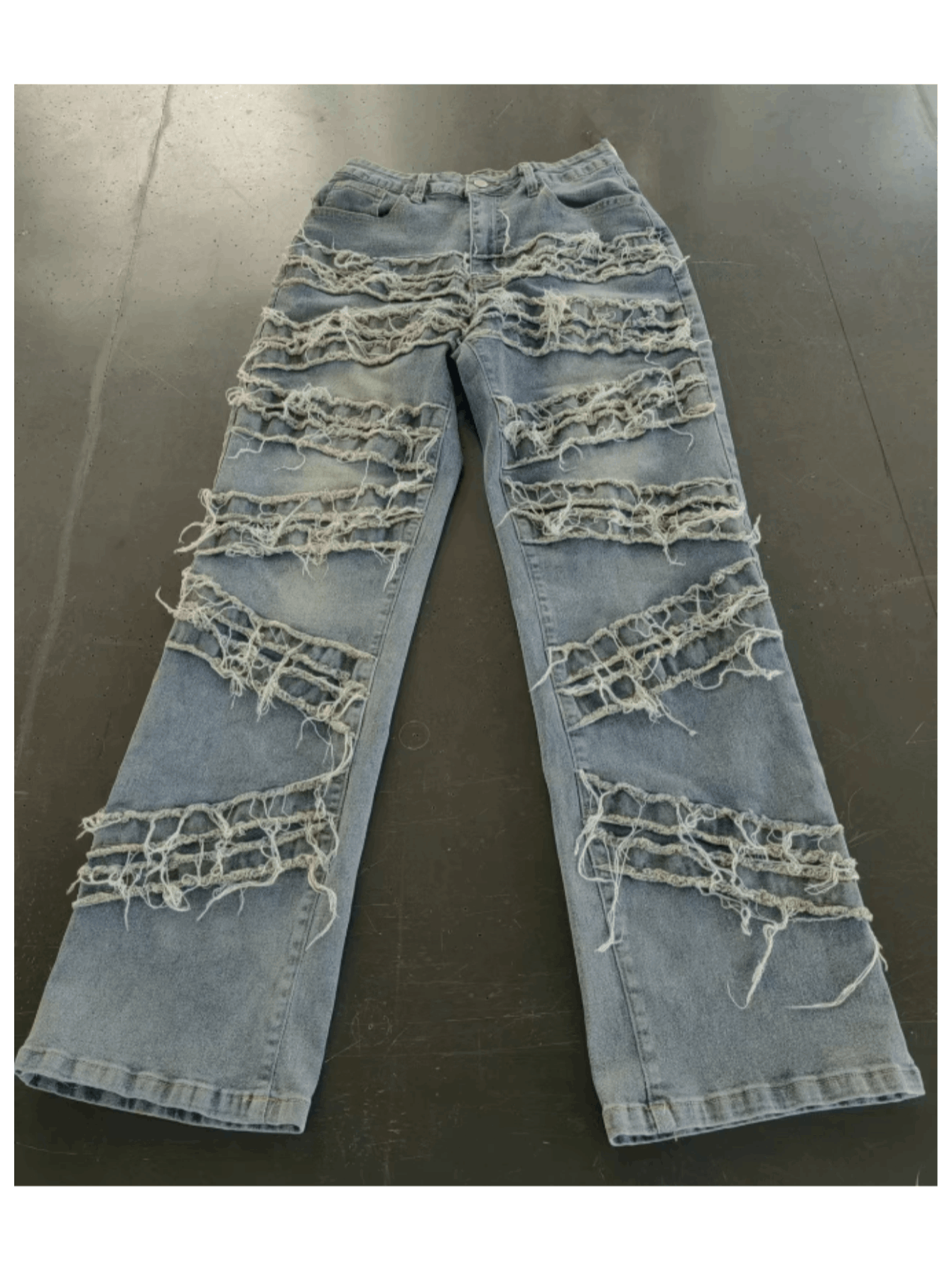 Vintage-style women's water-washed distressed pants with slit at the hem, made of denim fabric.