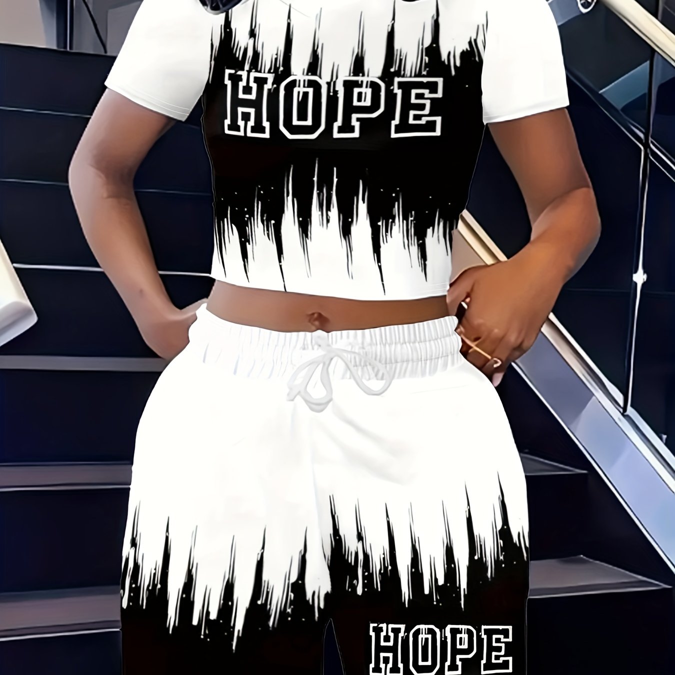 A Stylish Two-Piece Set for Women Featuring a Short-Sleeve Top with a Gradient Letter Pattern And Matching Shorts.