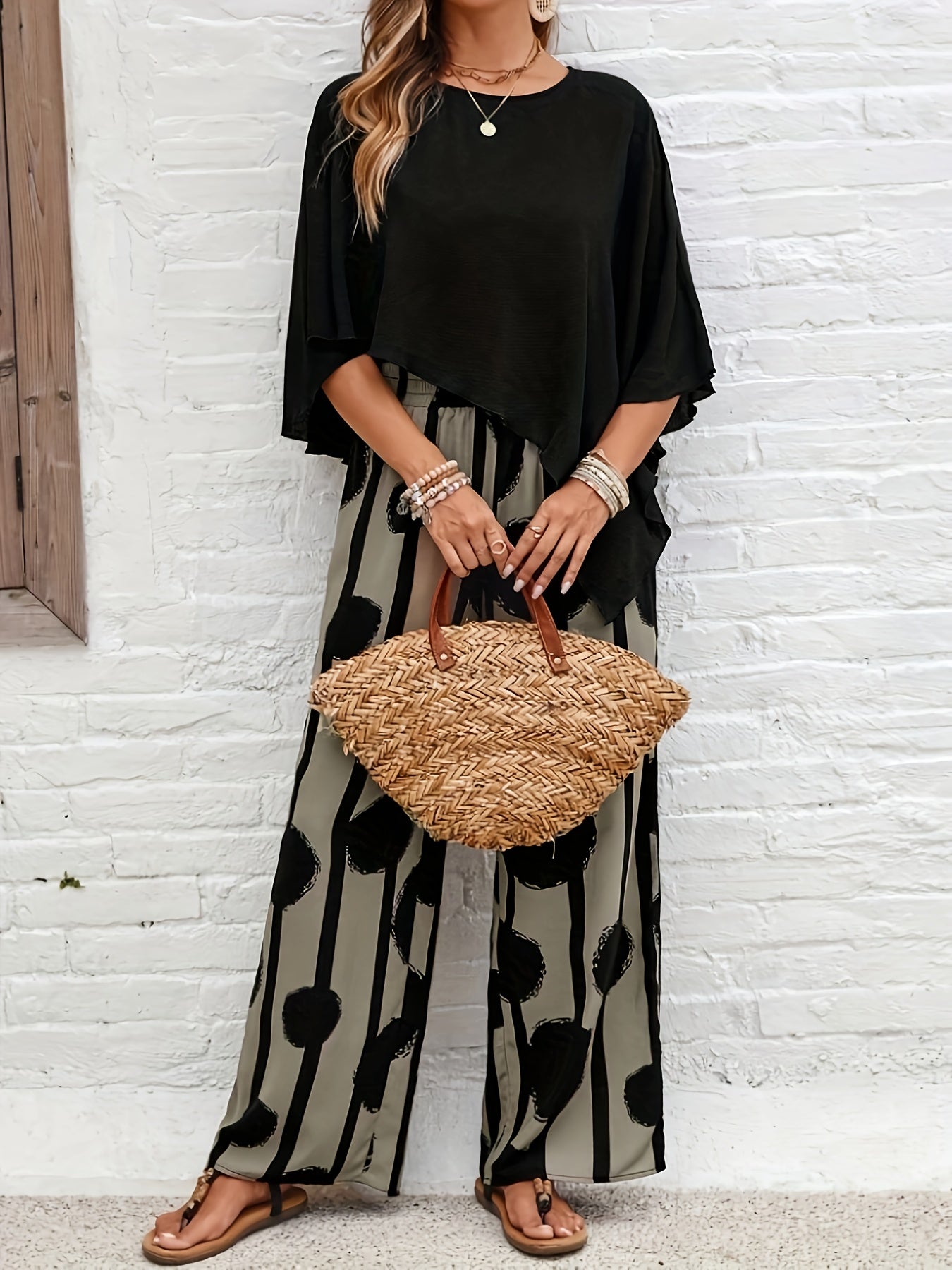 A Two-Piece Women'S Solid Color Round Neck Asymmetrical Hem Shirt And All-Over Printed Pants Set.