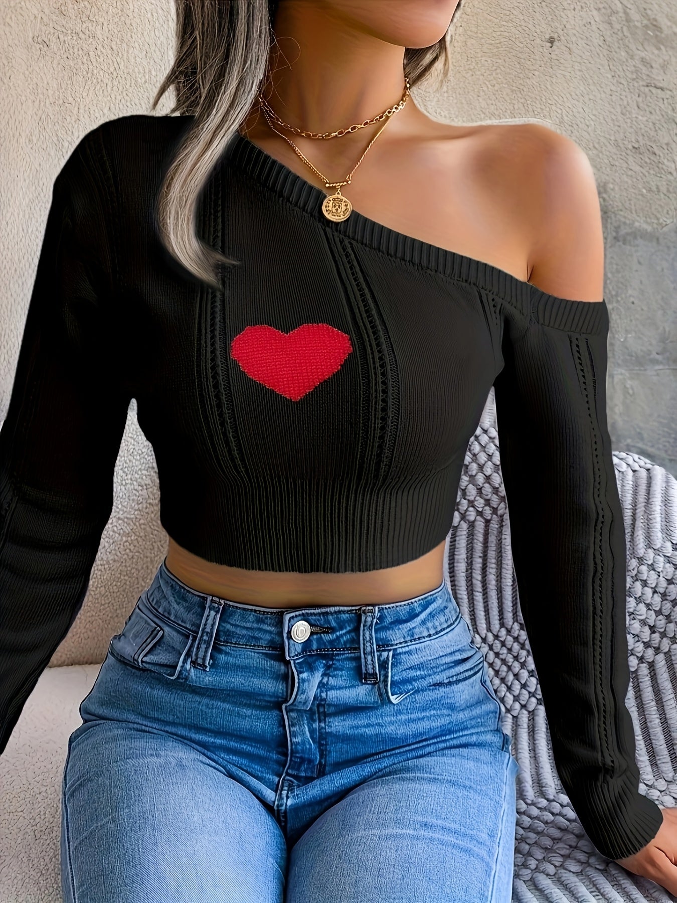 A Stylish Sweater with a Heart Design, Featuring an Elegant Off-Shoulder Look And a Fitted Knit Style.