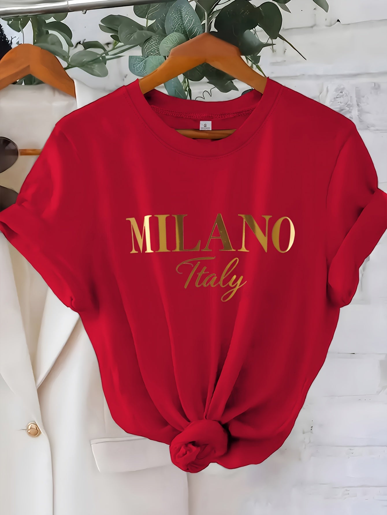 C571 Exuding elegance and modern luxury the design features MILANO in bold shimmering Golden uppercase letters with ITALY elegantly scripted in a smaller lighter font directly beneath all set against a deep black background T