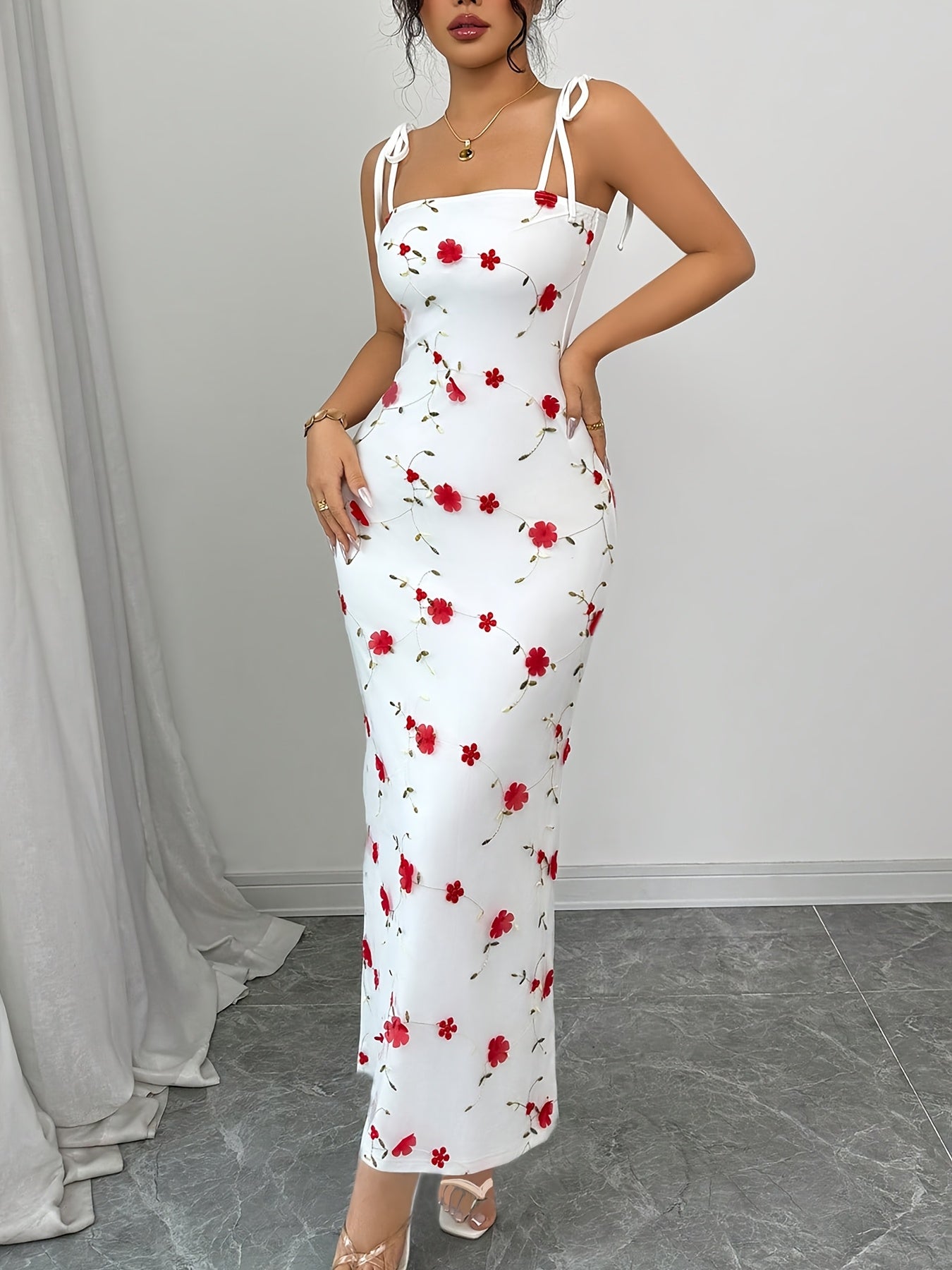 A Simple, Fitted Long Dress with Thin Shoulder Straps And a Waist Belt.