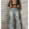 Vintage-style women's water-washed distressed pants with slit at the hem, made of denim fabric.