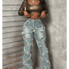 Vintage-style women's water-washed distressed pants with slit at the hem, made of denim fabric.