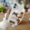 A Single-Pack Plush Teddy Bear Phone Case with a Bow, Available in White And Brown. It Comes with a Wrist Strap And Features a Simple And Elegant Faux Leather Texture That Is Anti-Slip And Fingerprint-Resistant. Made with TPU