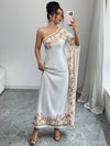 An Elegant Long Dress with an Asymmetrical Floral Print on The Shoulder, Suitable for Formal Occasions.