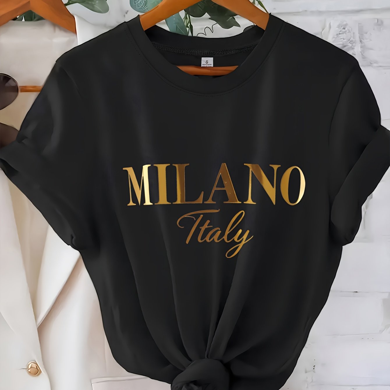 C571 Exuding elegance and modern luxury the design features MILANO in bold shimmering Golden uppercase letters with ITALY elegantly scripted in a smaller lighter font directly beneath all set against a deep black background T