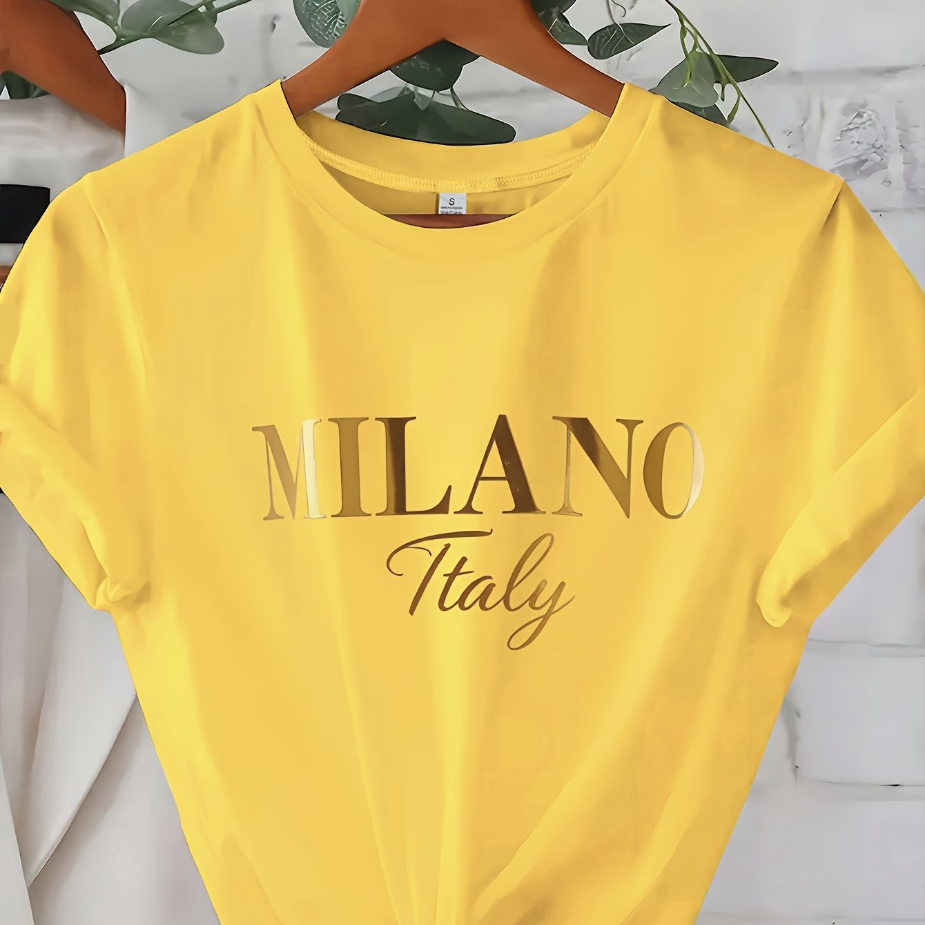 C571 Exuding elegance and modern luxury the design features MILANO in bold shimmering Golden uppercase letters with ITALY elegantly scripted in a smaller lighter font directly beneath all set against a deep black background T