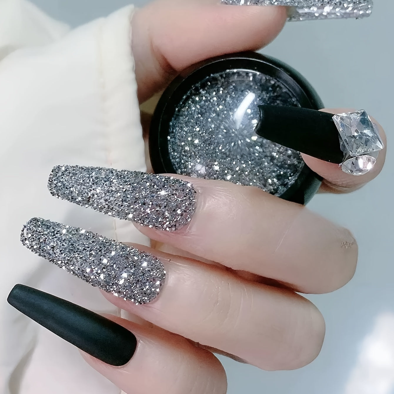 A Box of Tiny Silvery Triangular 3D Glittering Rhinestones, Perfect for Parties, Nightclubs, Music Festivals, And Vacation Nail Art Accessories.