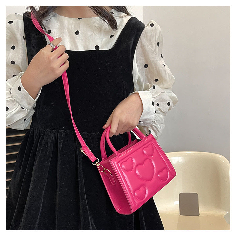1pc Women’s Stylish Solid Color Handbag with Detachable Strap – Heart Pattern Design, Perfect for Valentine’s Day Gift, Available in Magenta, White, Black, Green, Yellow