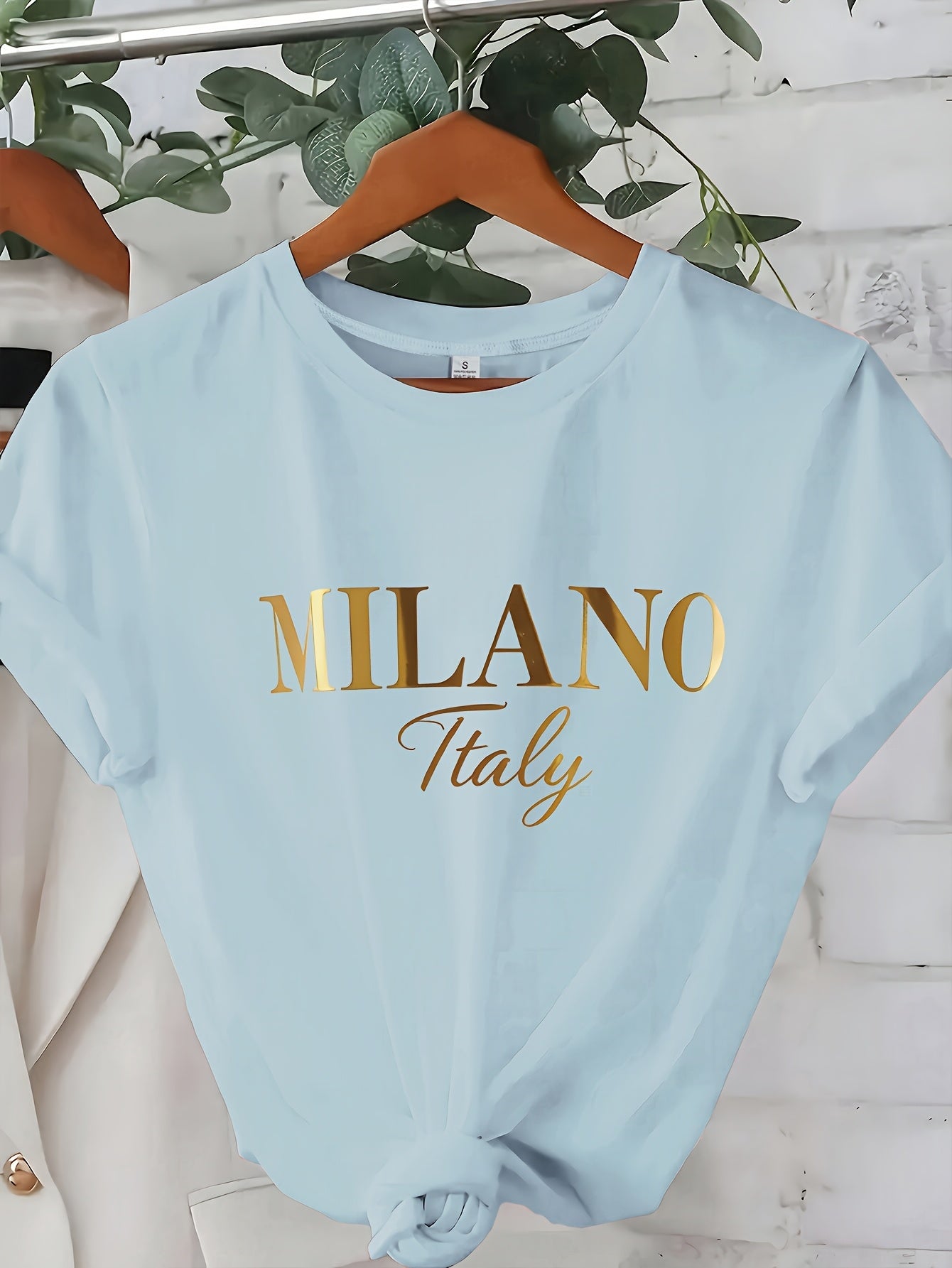 C571 Exuding elegance and modern luxury the design features MILANO in bold shimmering Golden uppercase letters with ITALY elegantly scripted in a smaller lighter font directly beneath all set against a deep black background T