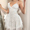 Fashionable Summer White Dress with a Halter Neck And Polka Dots, Featuring Removable Floral Decorations.