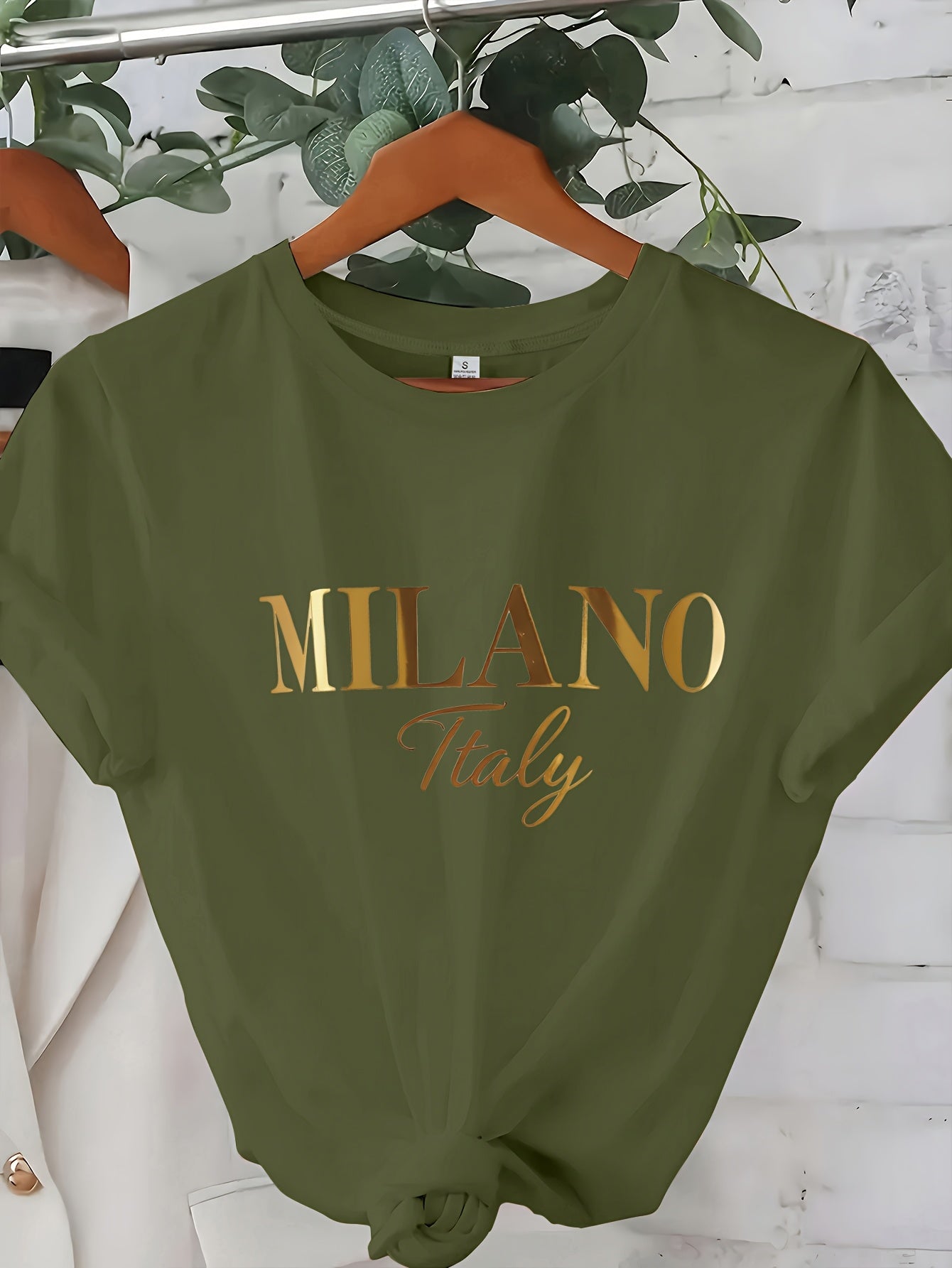 C571 Exuding elegance and modern luxury the design features MILANO in bold shimmering Golden uppercase letters with ITALY elegantly scripted in a smaller lighter font directly beneath all set against a deep black background T
