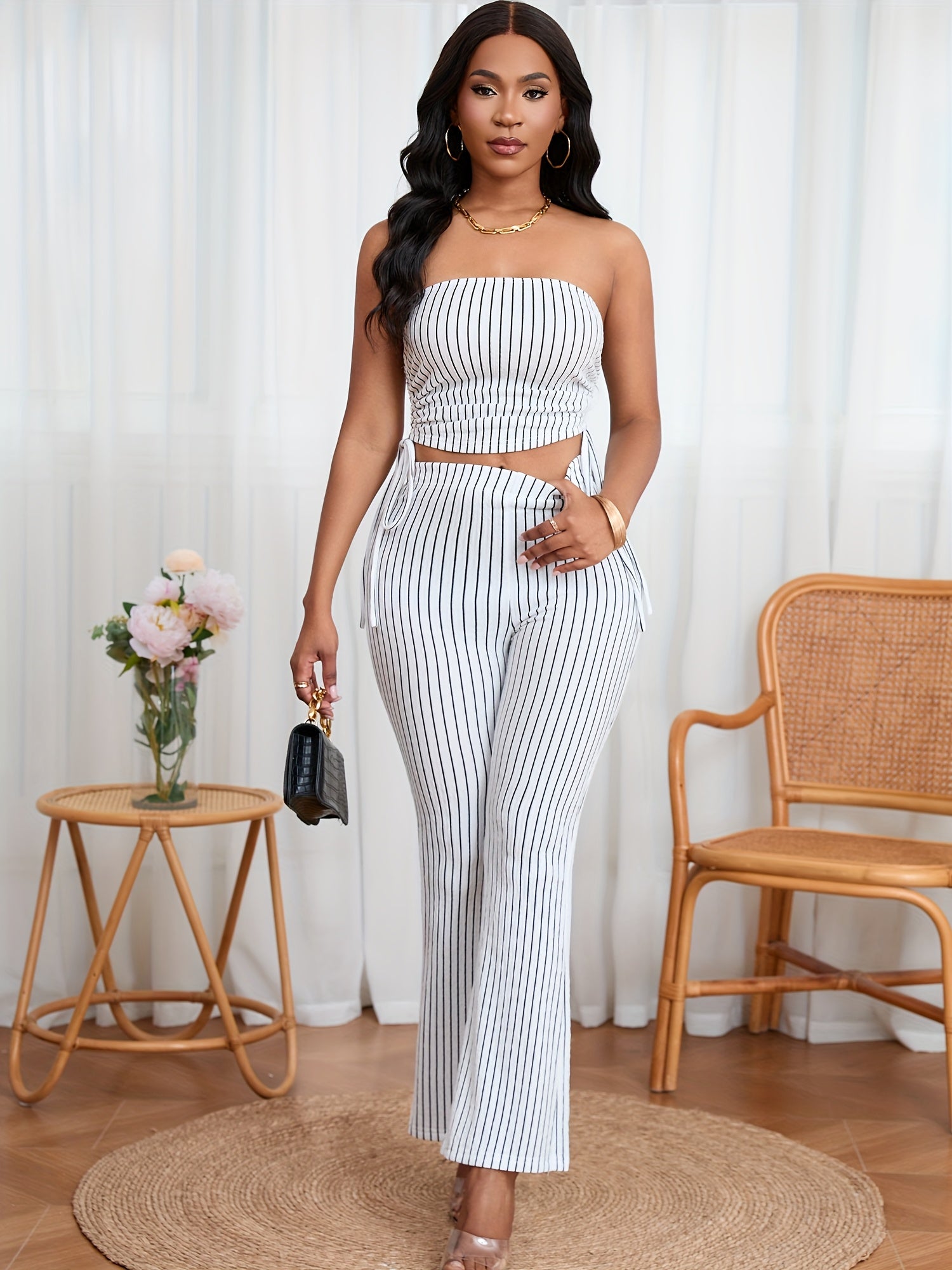 A Two-Piece Set Featuring a Textured Wrinkled Fabric Strapless Top with Drawstring And Fitted Flared Long Pants.