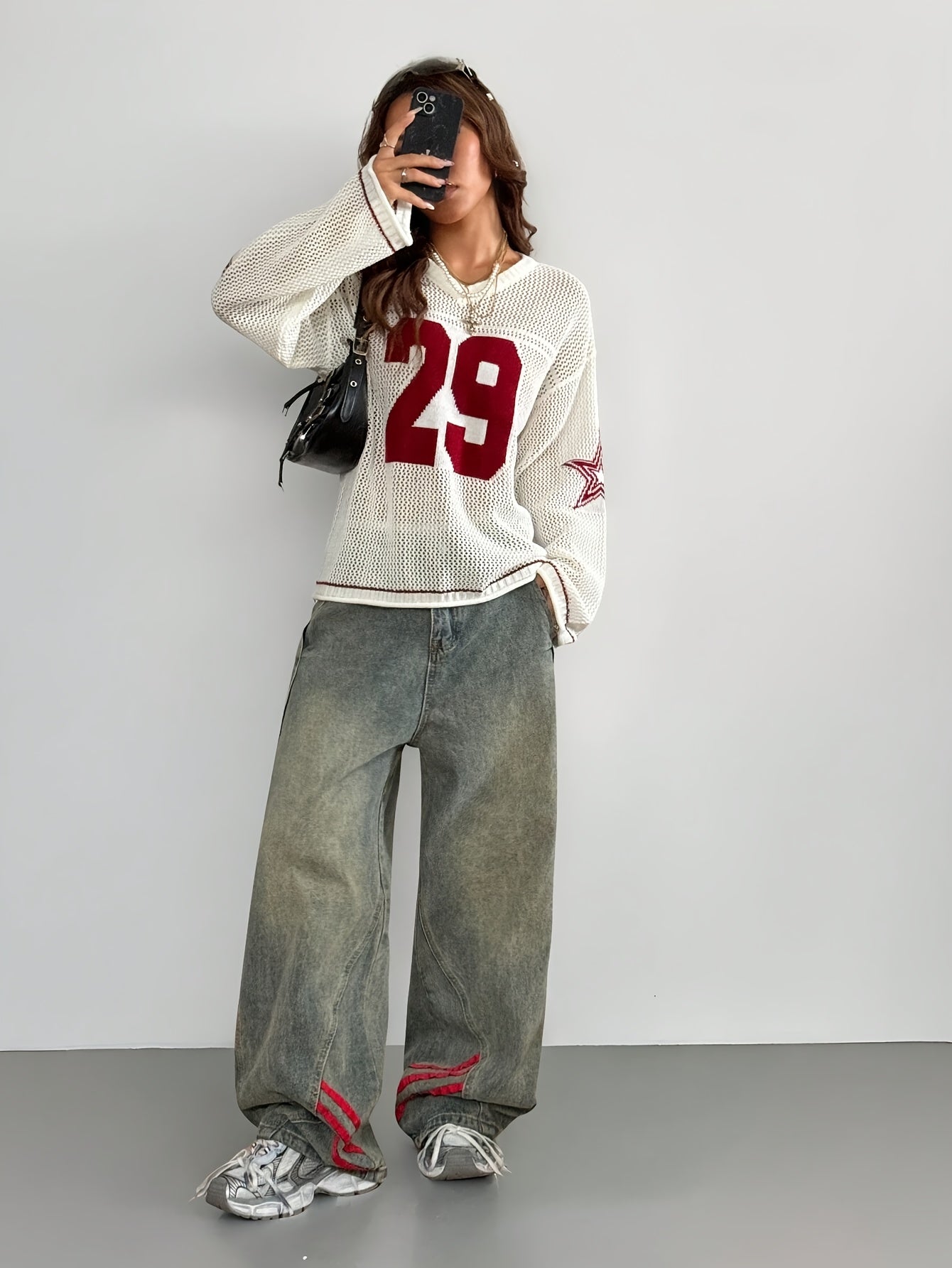 A Oversized Knitted Sweater with Striped And Number Prints, Featuring Long Sleeves.