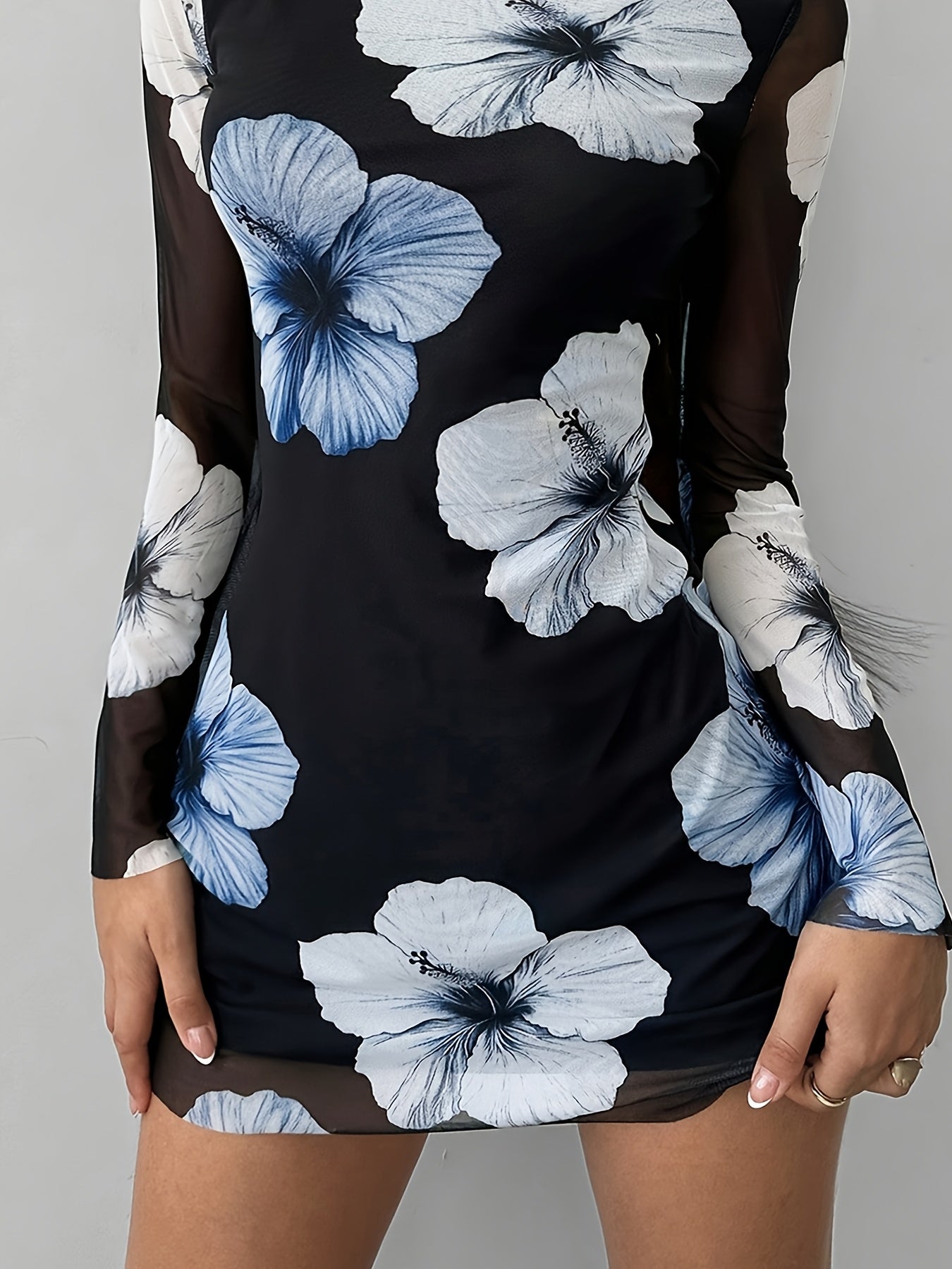 A Mini Dress with a Floral Print That Is Sexy And Elegant, Featuring a Backless Design And Breathable Long Sleeves.